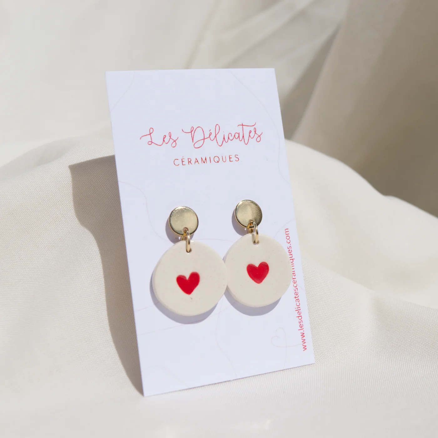 boucles d'oreilles en céramique blanche avec un cœur rouge